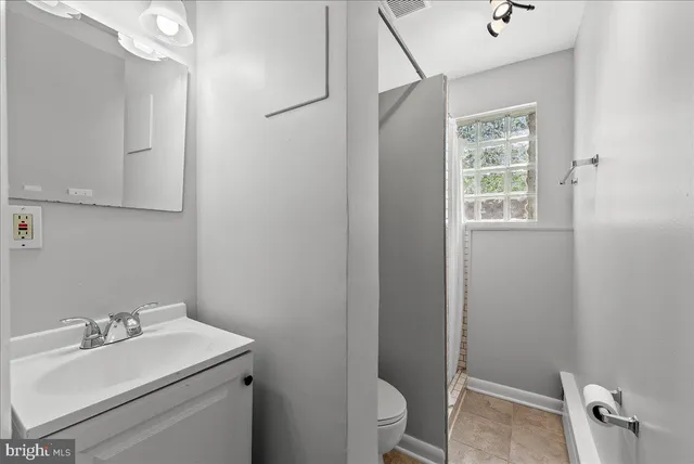 a bathroom with a sink toilet and vanity