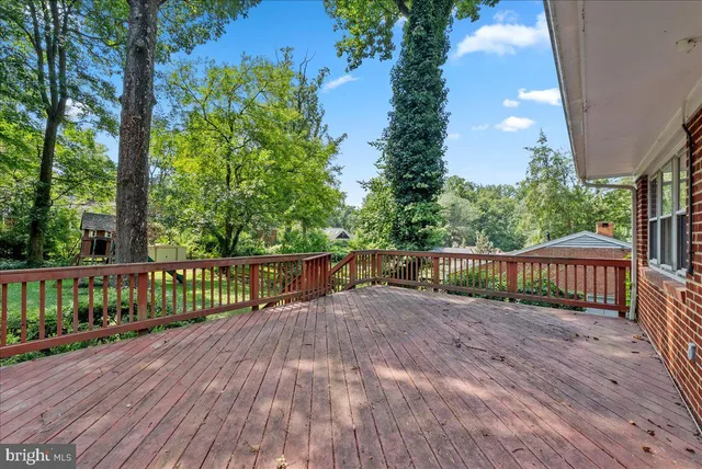 a view of balcony with wooden floor and fence