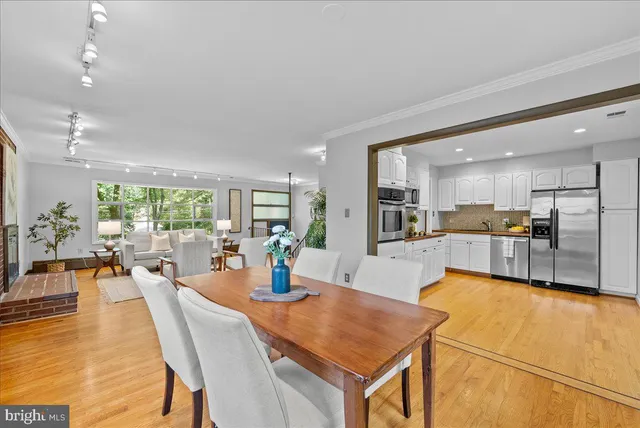 an open kitchen with dining table and chairs