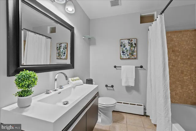 a bathroom with a sink mirror and toilet