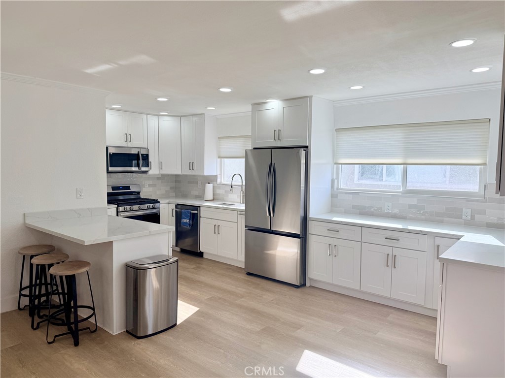 33932 Silver Lantern Street, Unit B Dana Point, CA 92629 - Photo 2 of 8 a kitchen with a refrigerator a sink and a microwave