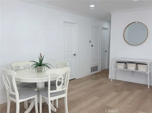 a dining room with furniture and a mirror
