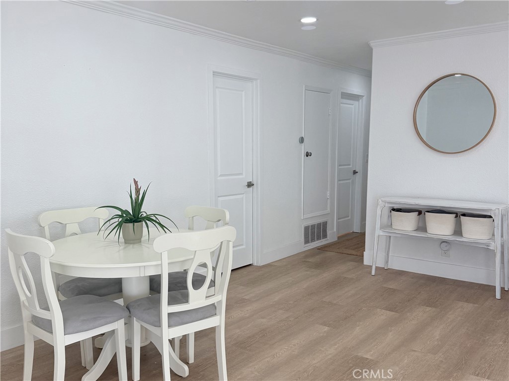 33932 Silver Lantern Street, Unit B Dana Point, CA 92629 - Photo 3 of 8 a dining room with furniture and a mirror