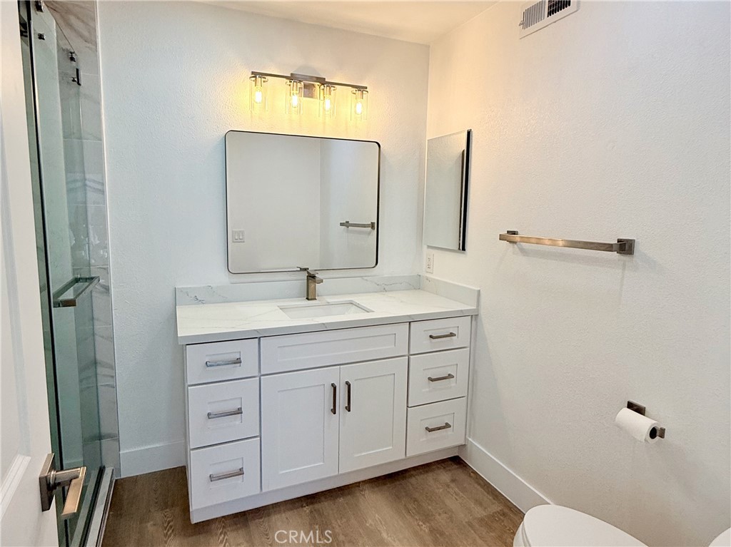 33932 Silver Lantern Street, Unit B Dana Point, CA 92629 - Photo 5 of 8 a bathroom with a double vanity sink and mirror