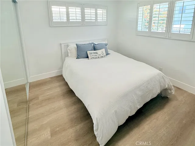 a large bed sitting in a bedroom next to a window