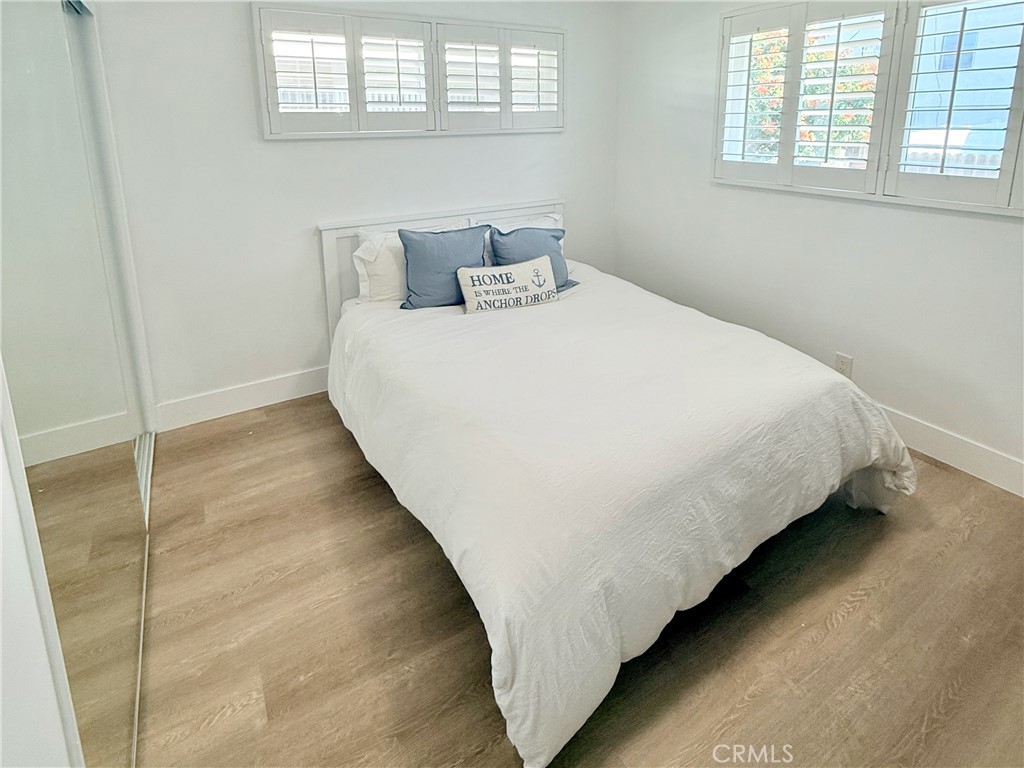33932 Silver Lantern Street, Unit B Dana Point, CA 92629 - Photo 6 of 8 a large bed sitting in a bedroom next to a window