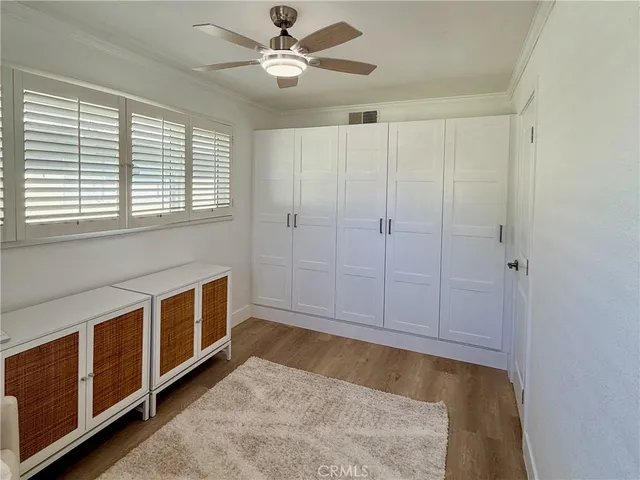 a view of an empty room with a window and closet
