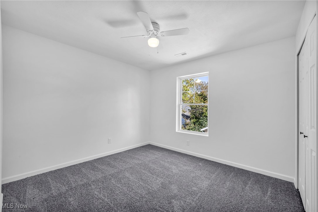 3653 Pennington Road Cleveland, OH 44120 - Photo 32 of 41 Carpeted empty room featuring baseboards and ceiling fan