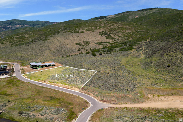910 Wasatch Drive Kamas, UT 84036 - Photo 2 of 36 Cleared 1.43-acre lot featuring a paved road frontage, defined property lines, and a mountainous natural backdrop