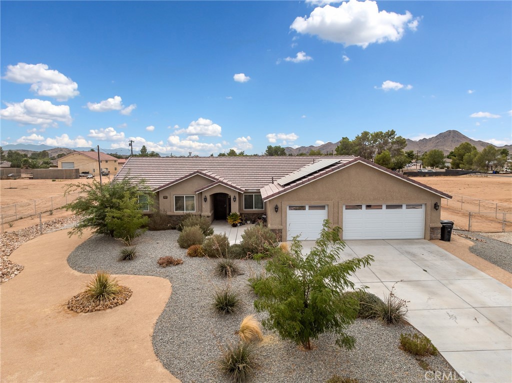15620 Erie Road Apple Valley, CA 92307 - Photo 3 of 53 a view of a house with a yard