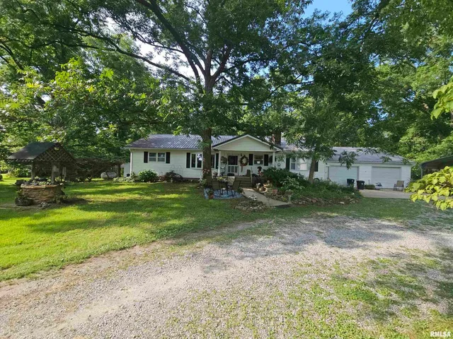 a front view of a house with a yard table and chairs
