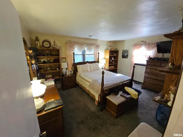 a bedroom with furniture and a flat screen tv