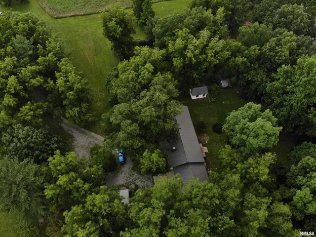 an aerial view of a house with a yard