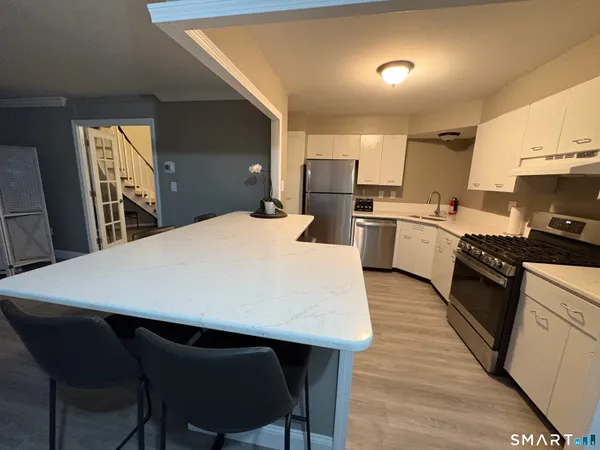 a large kitchen with a table and chairs in it