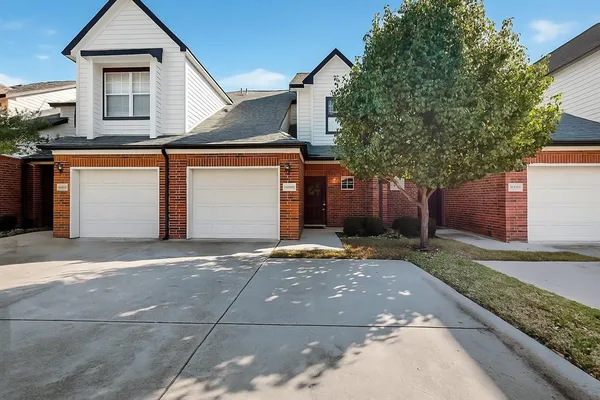 a front view of a house with garage