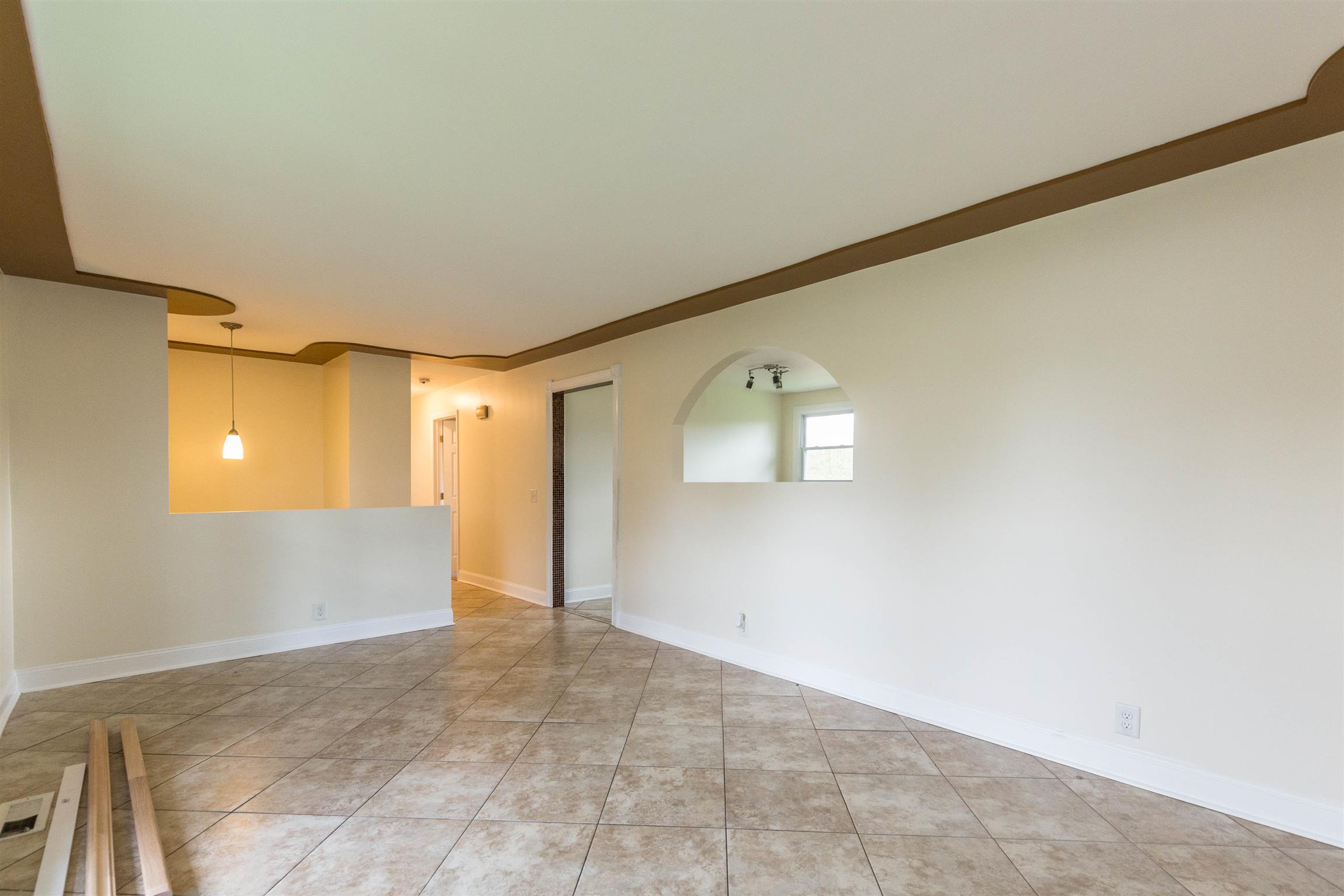 433 Cedarcliff Road Antioch, TN 37013 - Photo 11 of 30 Ample room in the living room with large picture windows. Pass thru opening in the kitchen allows a more open feel.