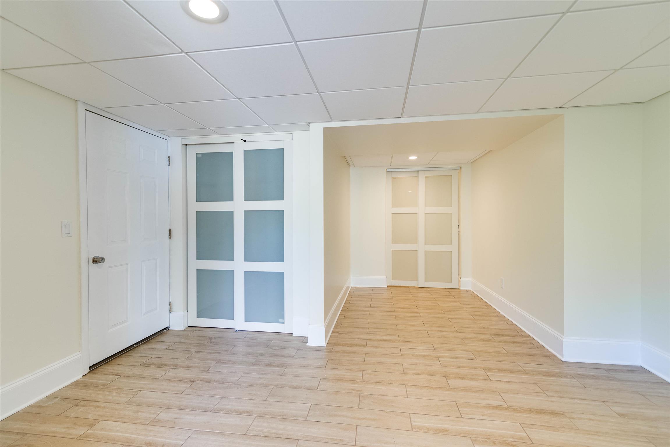 433 Cedarcliff Road Antioch, TN 37013 - Photo 22 of 30 Downstairs gathering room for entertaining guests. The door on the left is storage room and has water heater. The door in the right leads to the laundry room.
