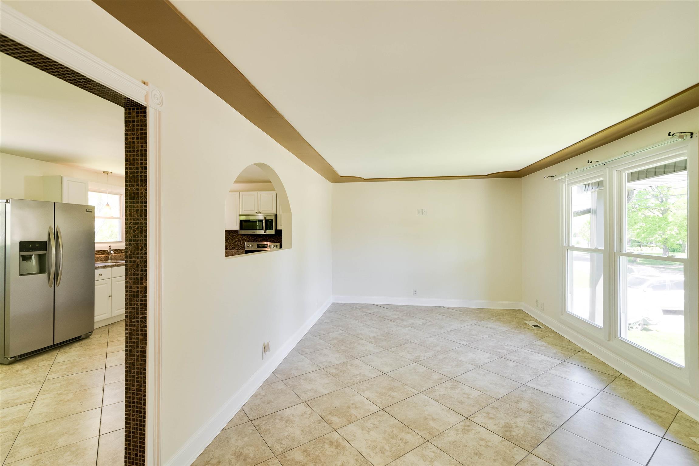 433 Cedarcliff Road Antioch, TN 37013 - Photo 9 of 30 Ample room in the living room with large picture windows. Pass thru opening in the kitchen allows a more open feel.