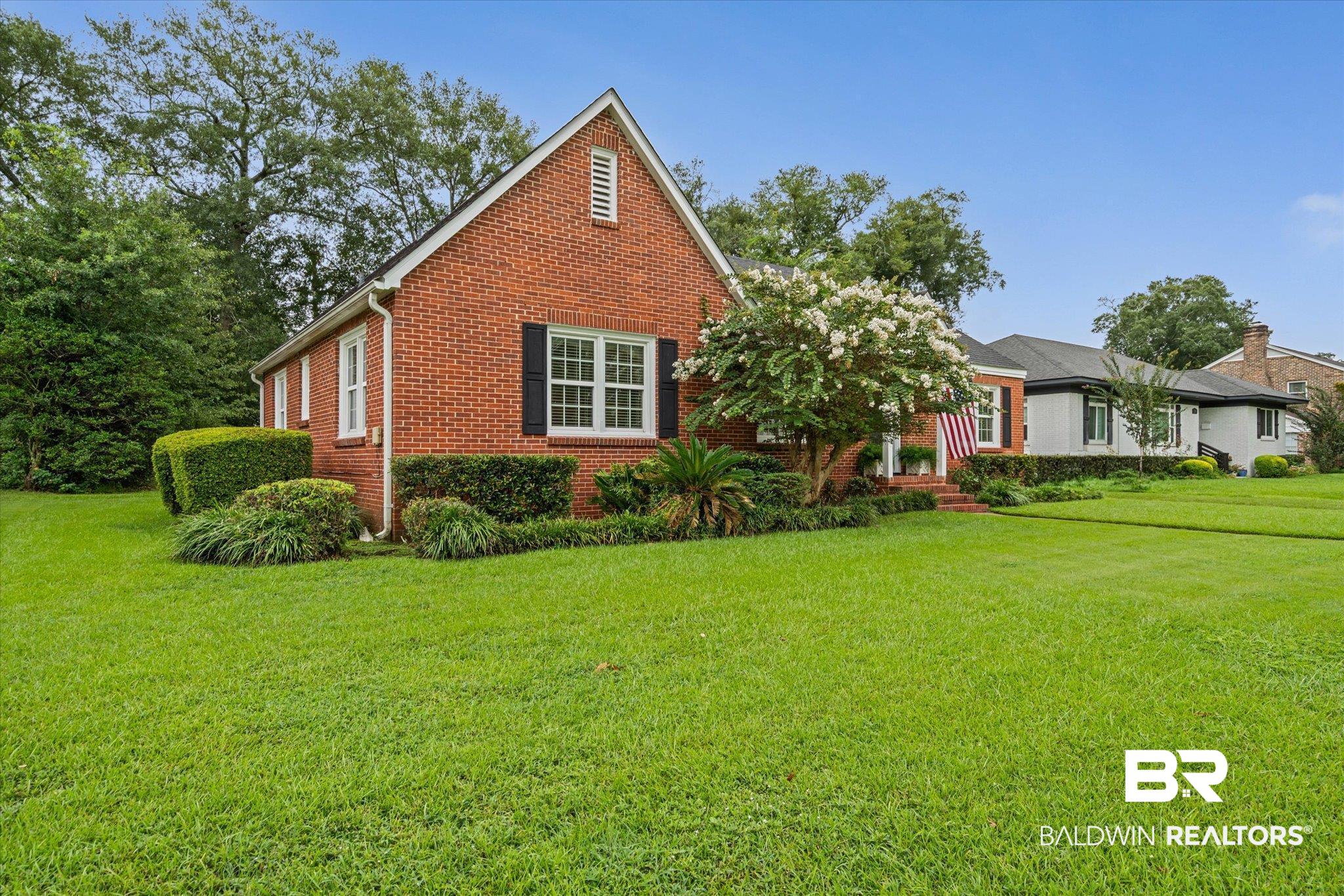 300 Woodlands Avenue Mobile, AL 36607 - Photo 21 of 23 View of front of home with a front yard and brick siding
