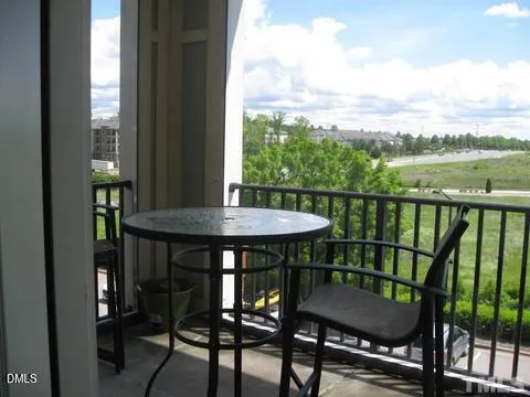 a view of a table and chairs in the balcony