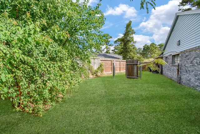 a view of a house with backyard and a garden