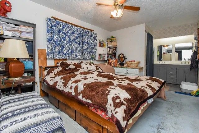 a bedroom with bed and wooden floor