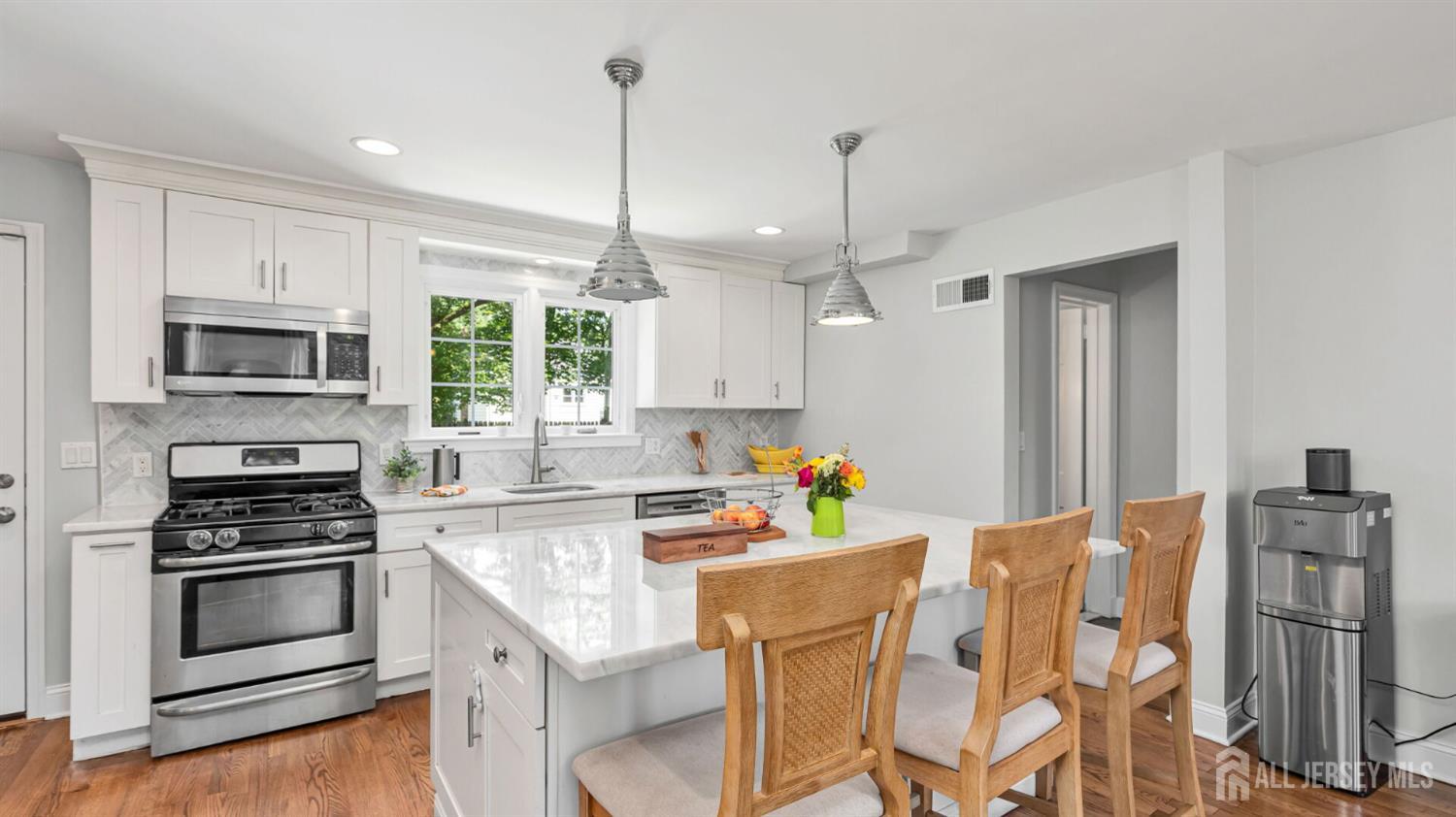 1085 Kenyon Avenue Plainfield, NJ 07060 - Photo 14 of 50 a kitchen with stainless steel appliances kitchen island granite countertop a refrigerator and microwave