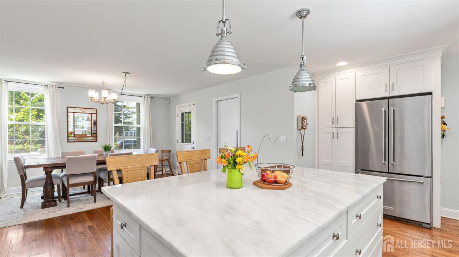 1085 Kenyon Avenue Plainfield, NJ 07060 - Photo 16 of 50 a kitchen with stainless steel appliances granite countertop a refrigerator a sink dishwasher a dining table and chairs with wooden floor