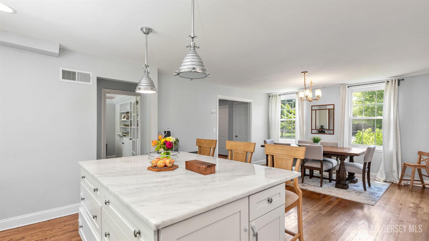 1085 Kenyon Avenue Plainfield, NJ 07060 - Photo 17 of 50 a view of a dining room and livingroom with furniture wooden floor a chandelier