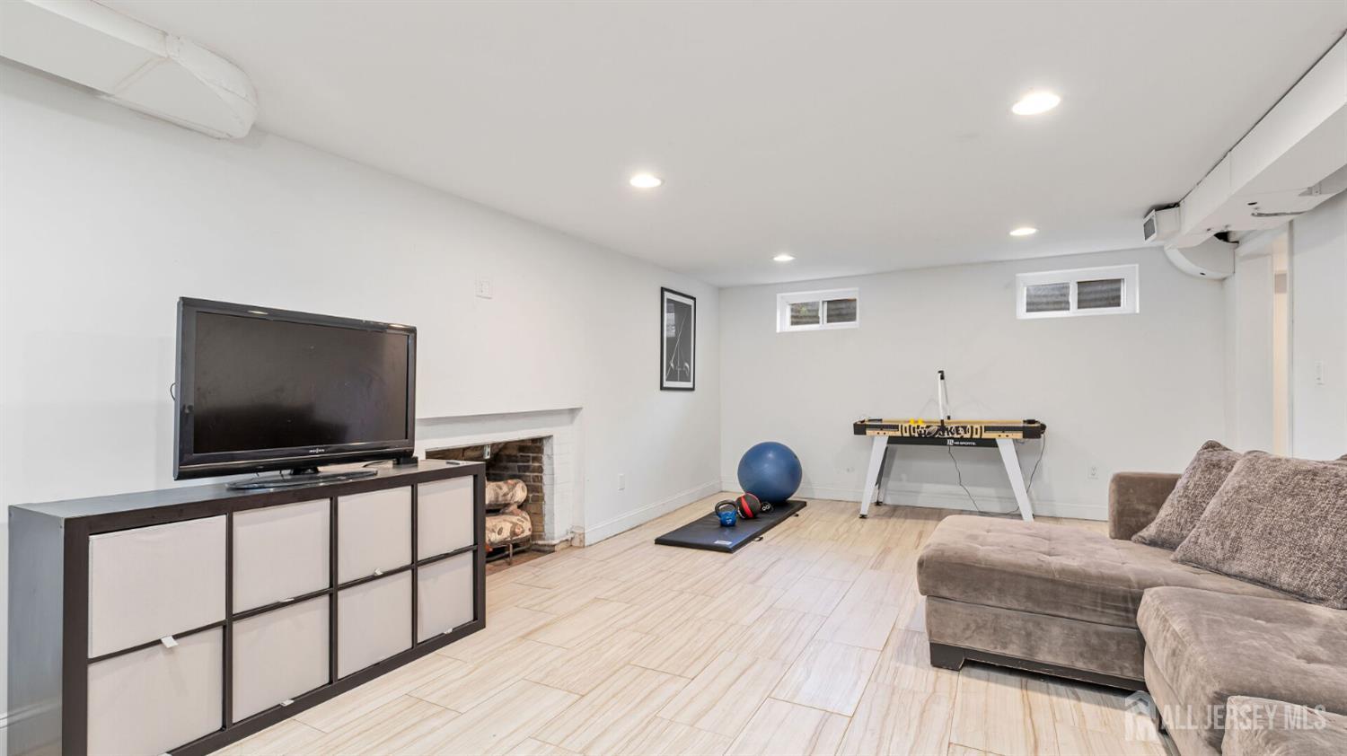 1085 Kenyon Avenue Plainfield, NJ 07060 - Photo 25 of 50 a living room with furniture and a flat screen tv