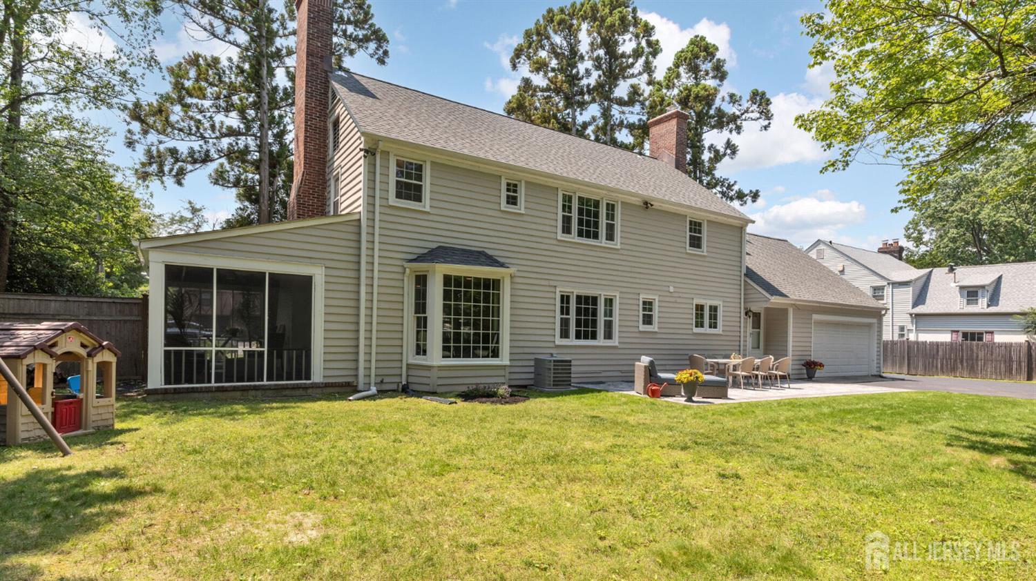 1085 Kenyon Avenue Plainfield, NJ 07060 - Photo 41 of 50 a front view of a house with a yard and garage