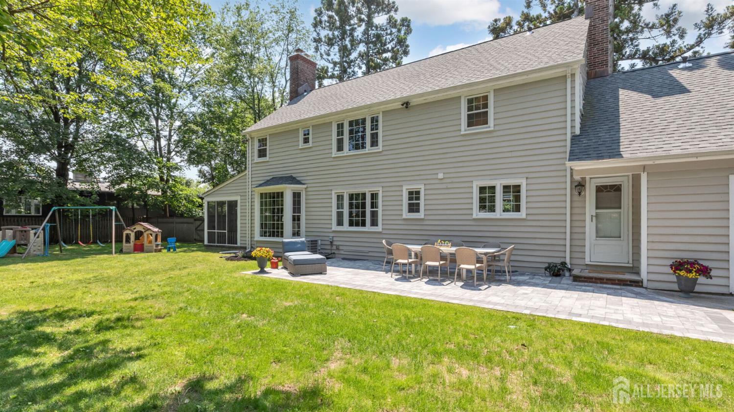 1085 Kenyon Avenue Plainfield, NJ 07060 - Photo 44 of 50 a backyard of a house with table and chairs with plants and wooden fence