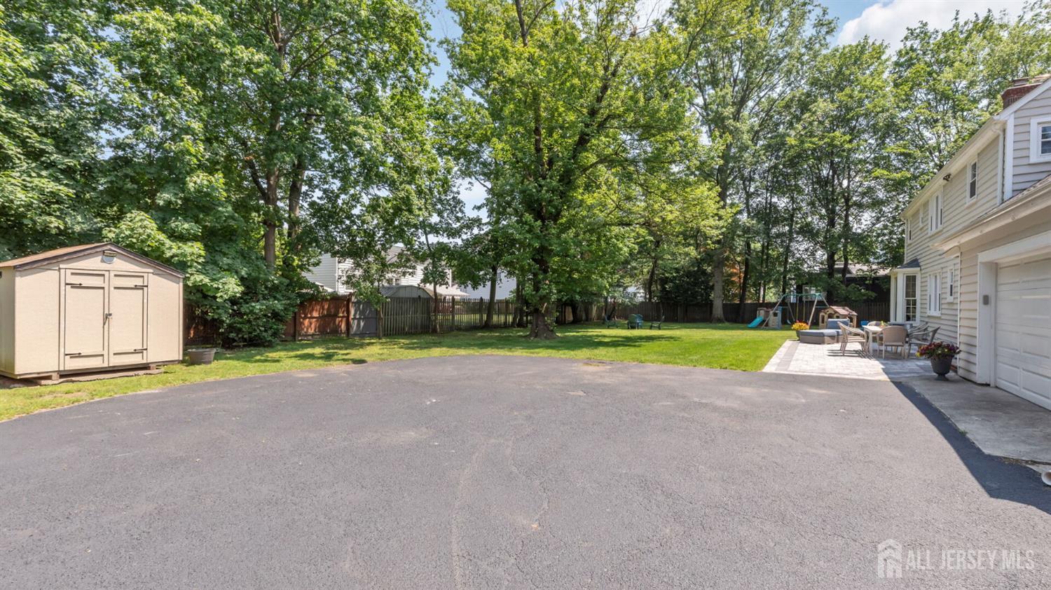 1085 Kenyon Avenue Plainfield, NJ 07060 - Photo 50 of 50 a view of a house with a big yard and large trees