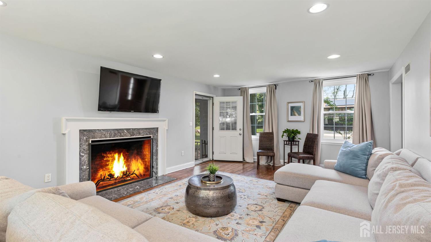 1085 Kenyon Avenue Plainfield, NJ 07060 - Photo 8 of 50 a living room with furniture a flat screen tv and a fireplace