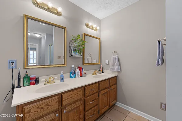 a bathroom with a double vanity sink and a mirror