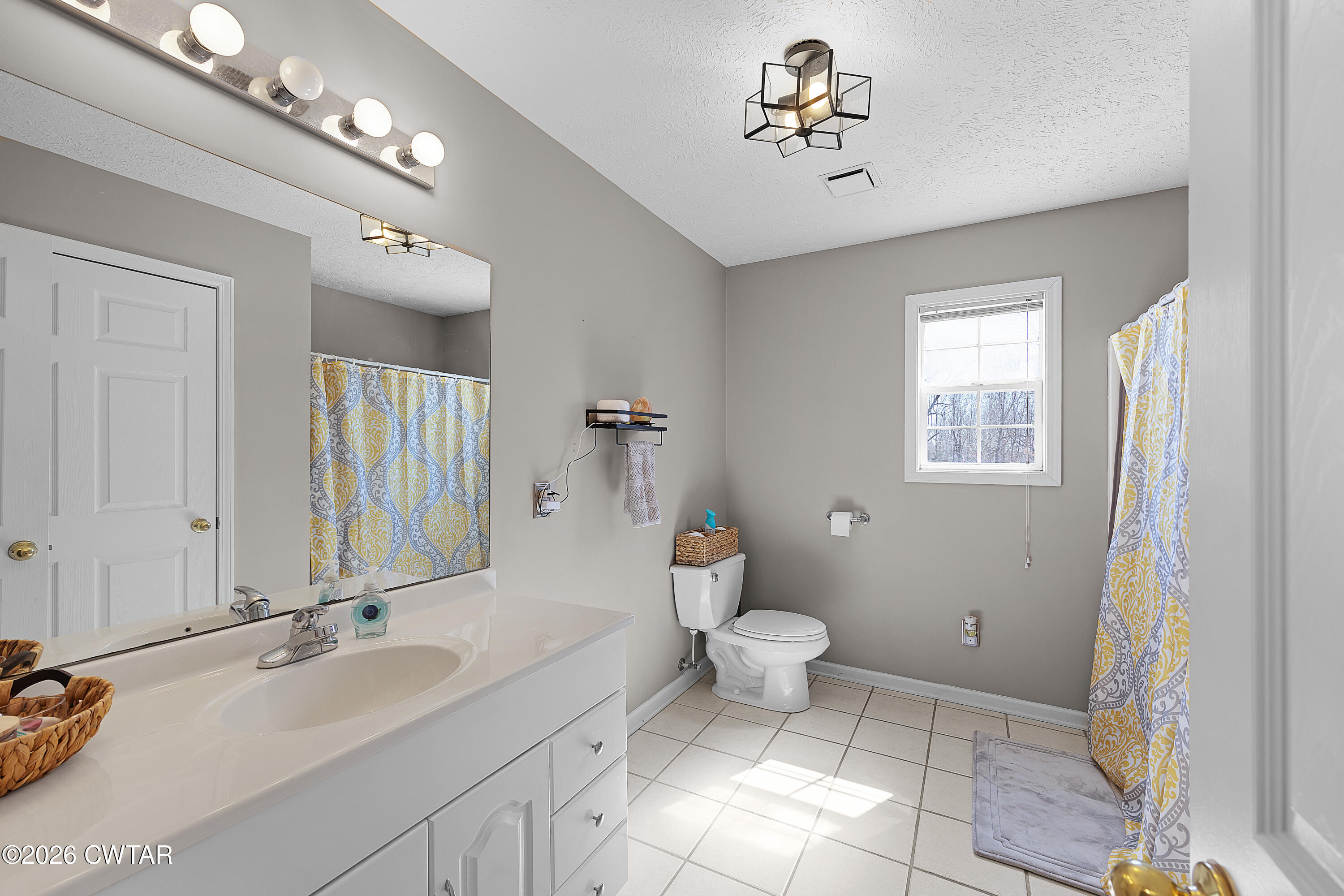 184 Deep Gap Road Jackson, TN 38301 - Photo 22 of 31 a bathroom with a sink a toilet and a mirror