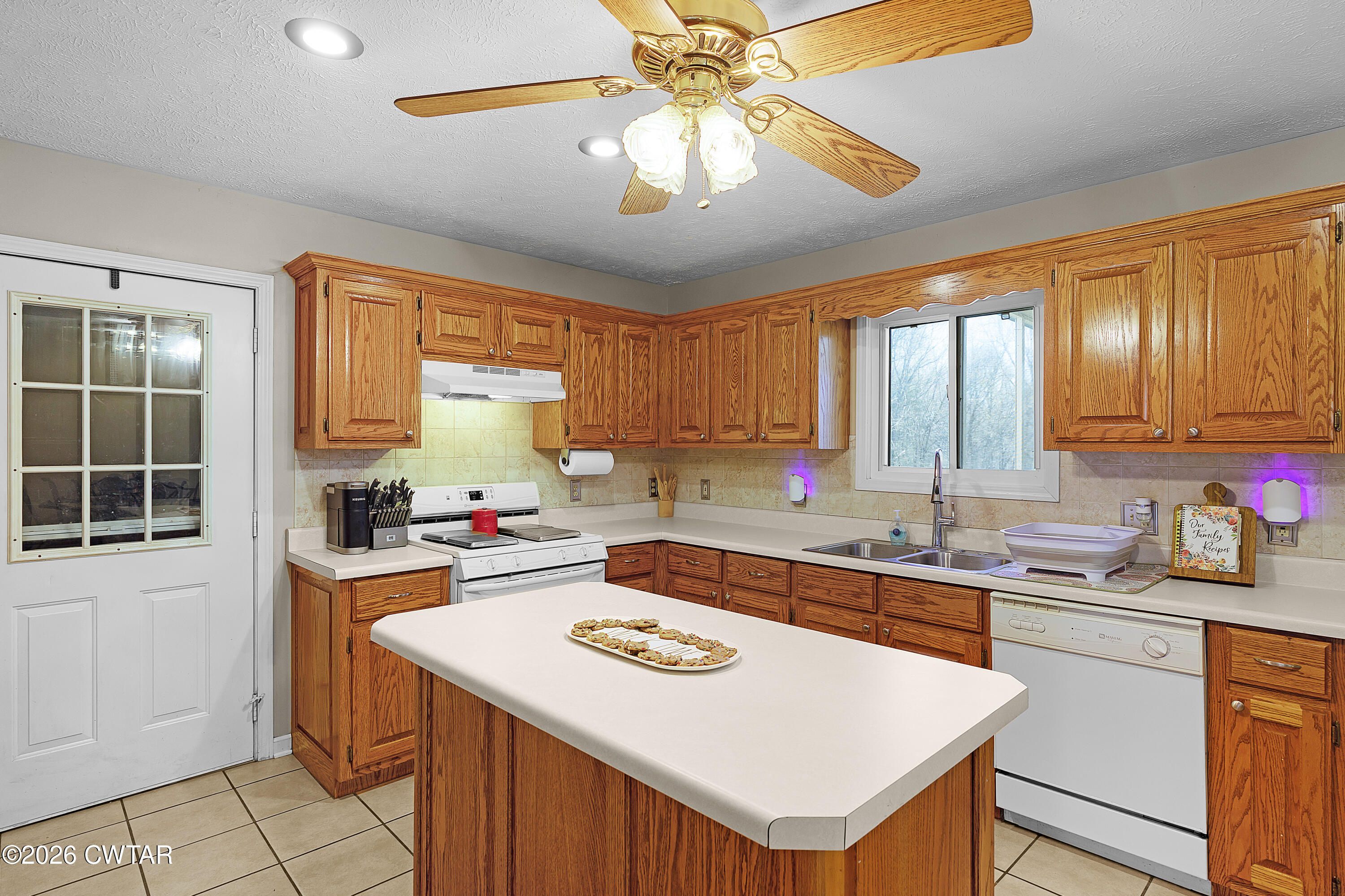 184 Deep Gap Road Jackson, TN 38301 - Photo 8 of 31 a kitchen with a stove a sink dishwasher and a refrigerator