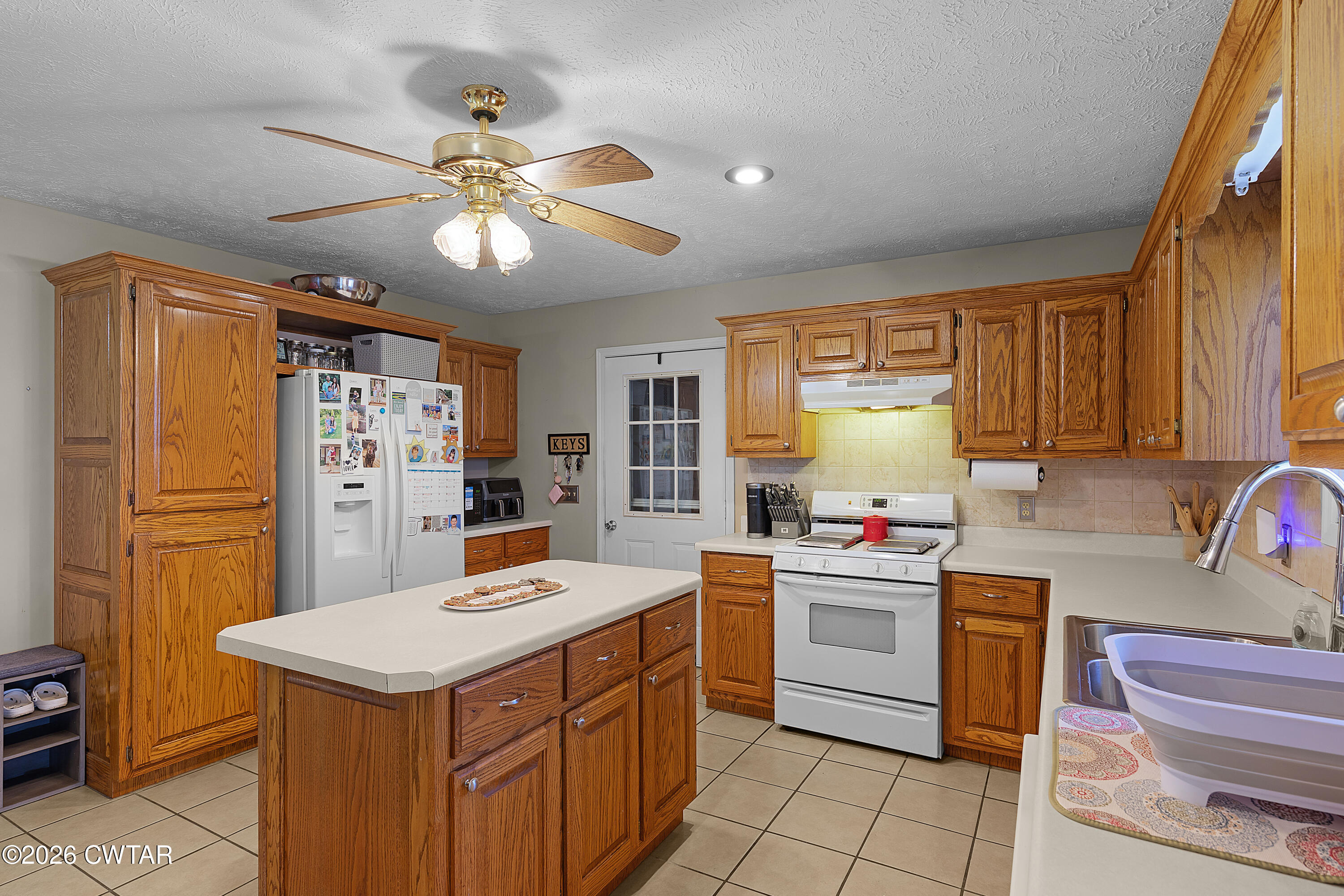 184 Deep Gap Road Jackson, TN 38301 - Photo 9 of 31 a kitchen with a stove a sink dishwasher and a refrigerator with wooden floor