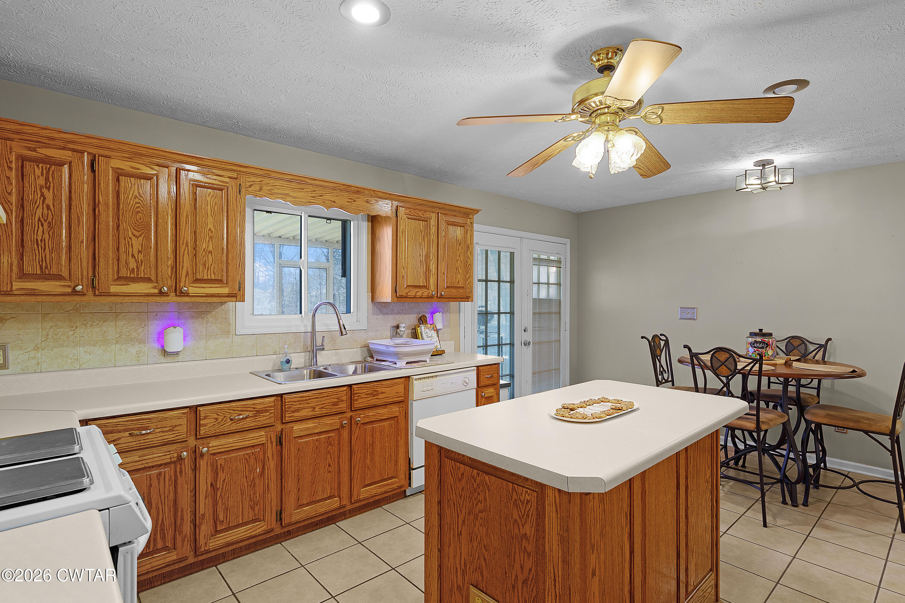 184 Deep Gap Road Jackson, TN 38301 - Photo 10 of 31 a kitchen with a stove a sink a dining table and chairs