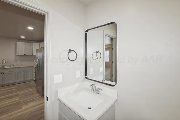 a bathroom with a sink vanity and a mirror