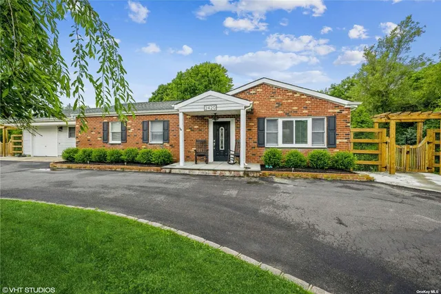 a front view of a house with a garden