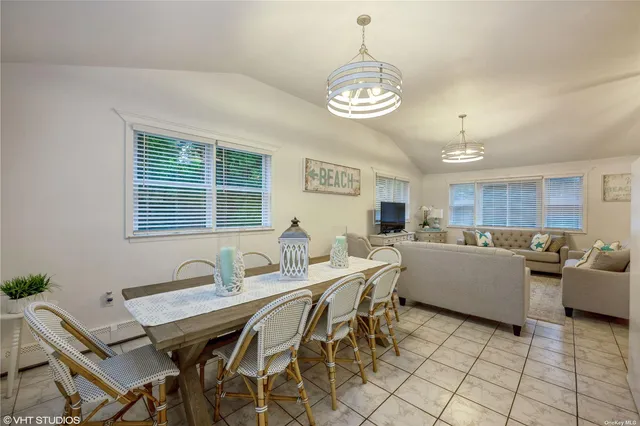a view of a dining room with furniture and chandelier