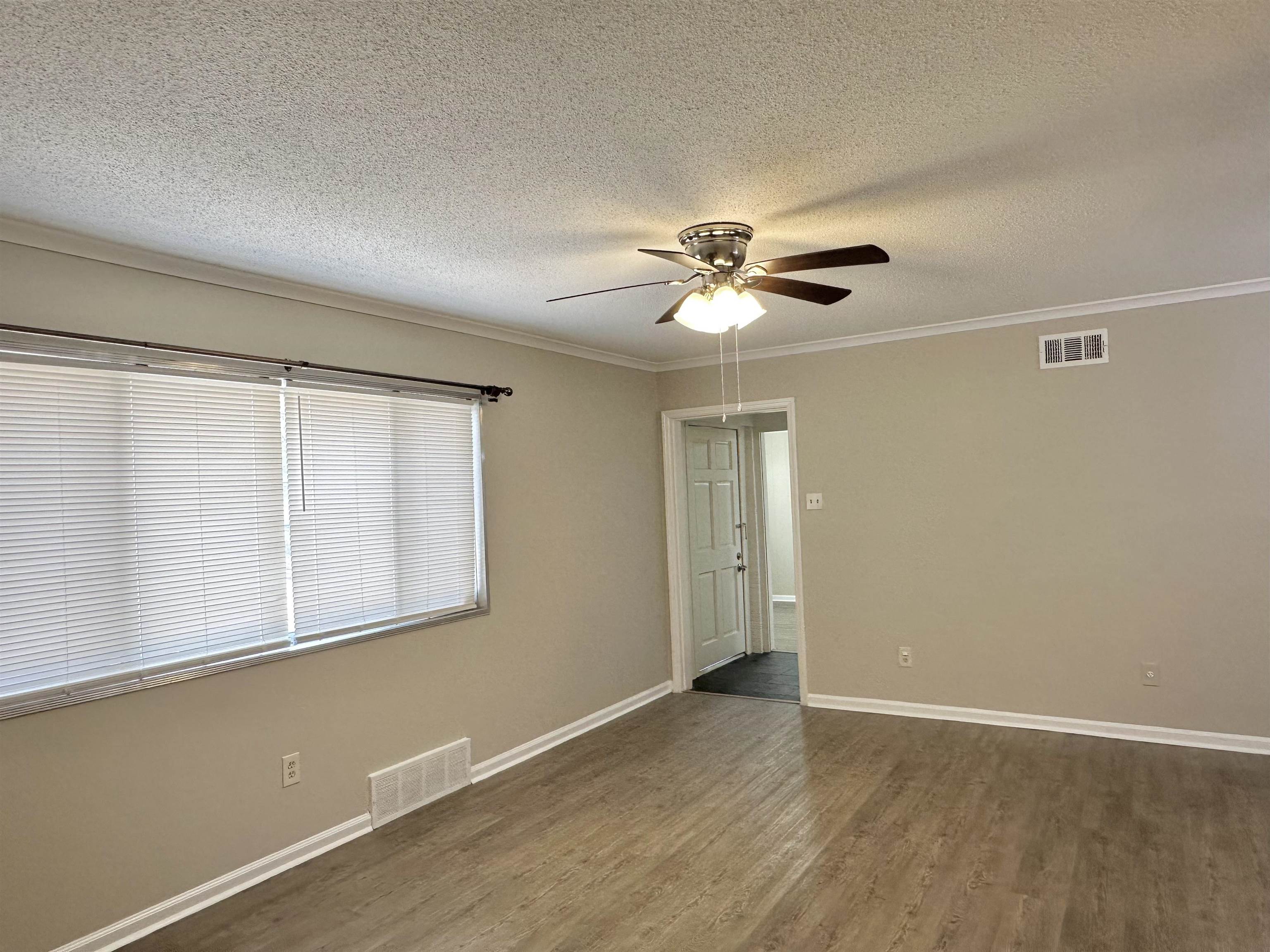 141 North White Station Road Memphis, TN 38117 - Photo 11 of 24 an empty room with wooden floor and windows