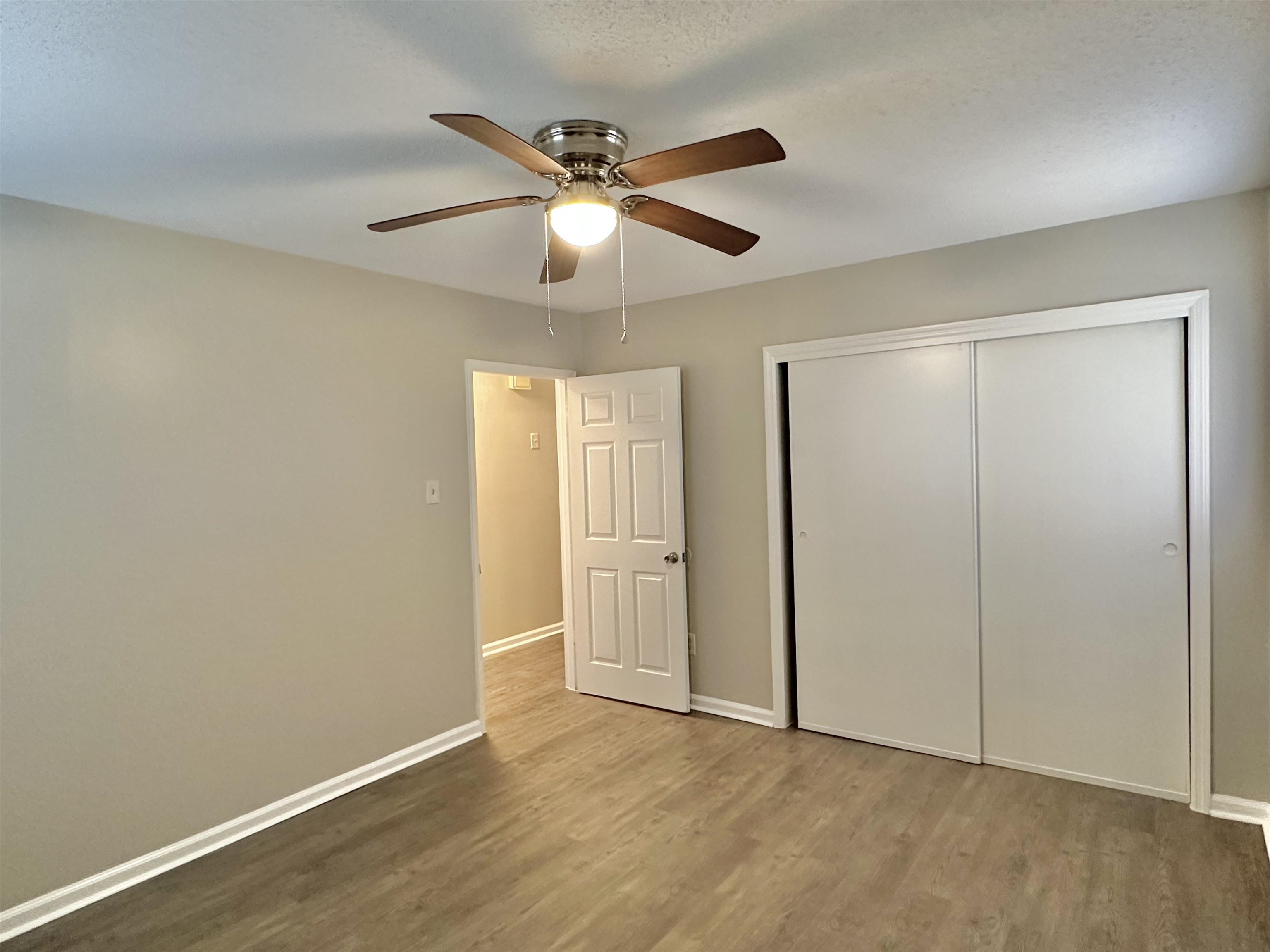 141 North White Station Road Memphis, TN 38117 - Photo 18 of 24 an empty room with wooden floor fan and windows