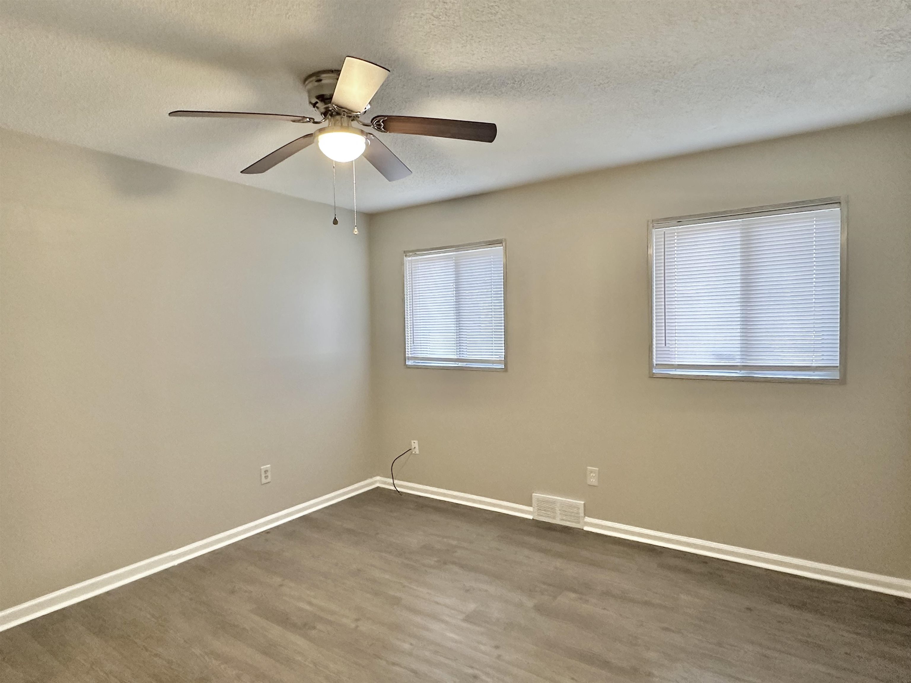 141 North White Station Road Memphis, TN 38117 - Photo 19 of 24 a view of an empty room with wooden floor and a ceiling fan