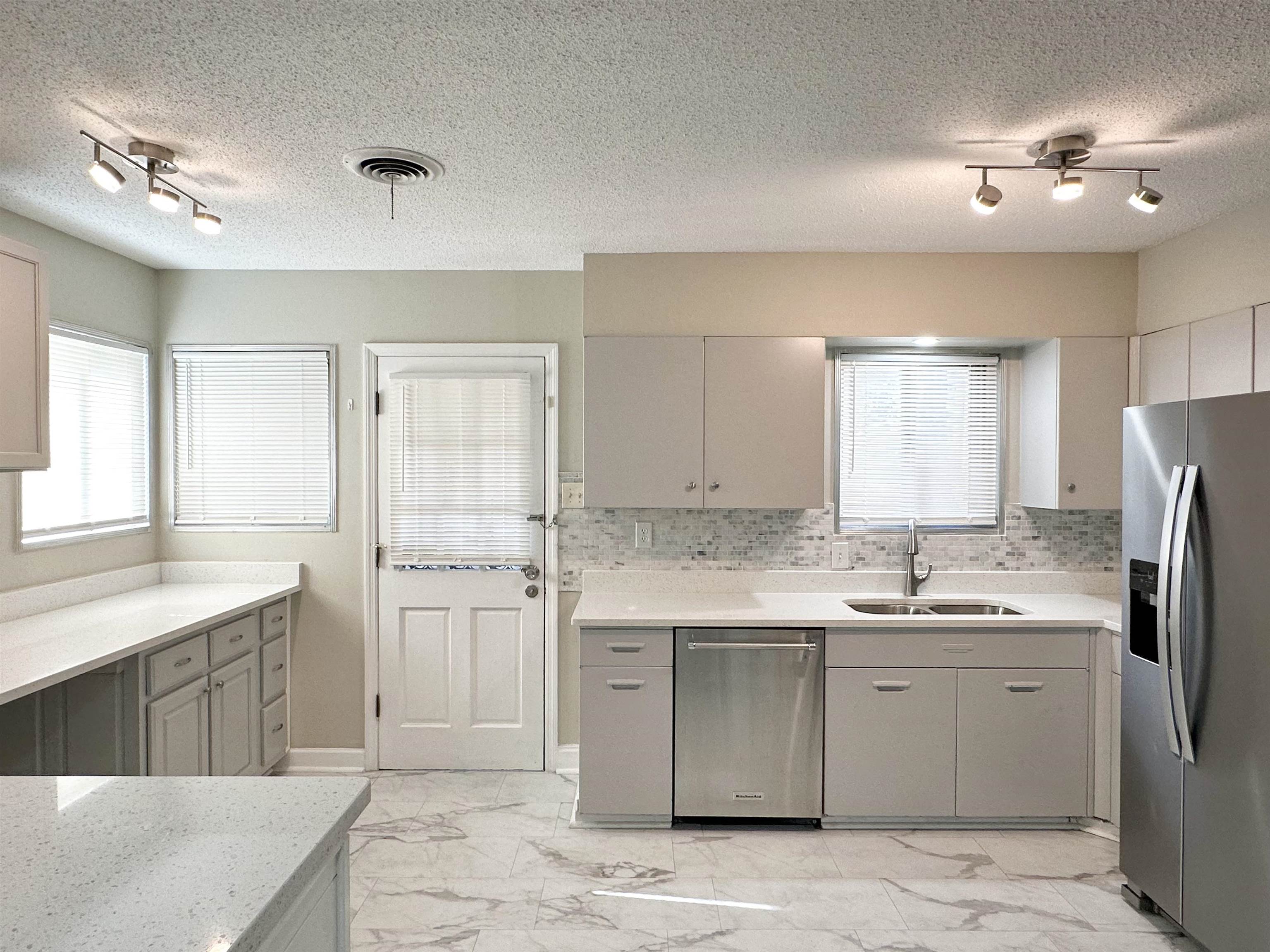141 North White Station Road Memphis, TN 38117 - Photo 7 of 24 a kitchen with a sink dishwasher a refrigerator and cabinets