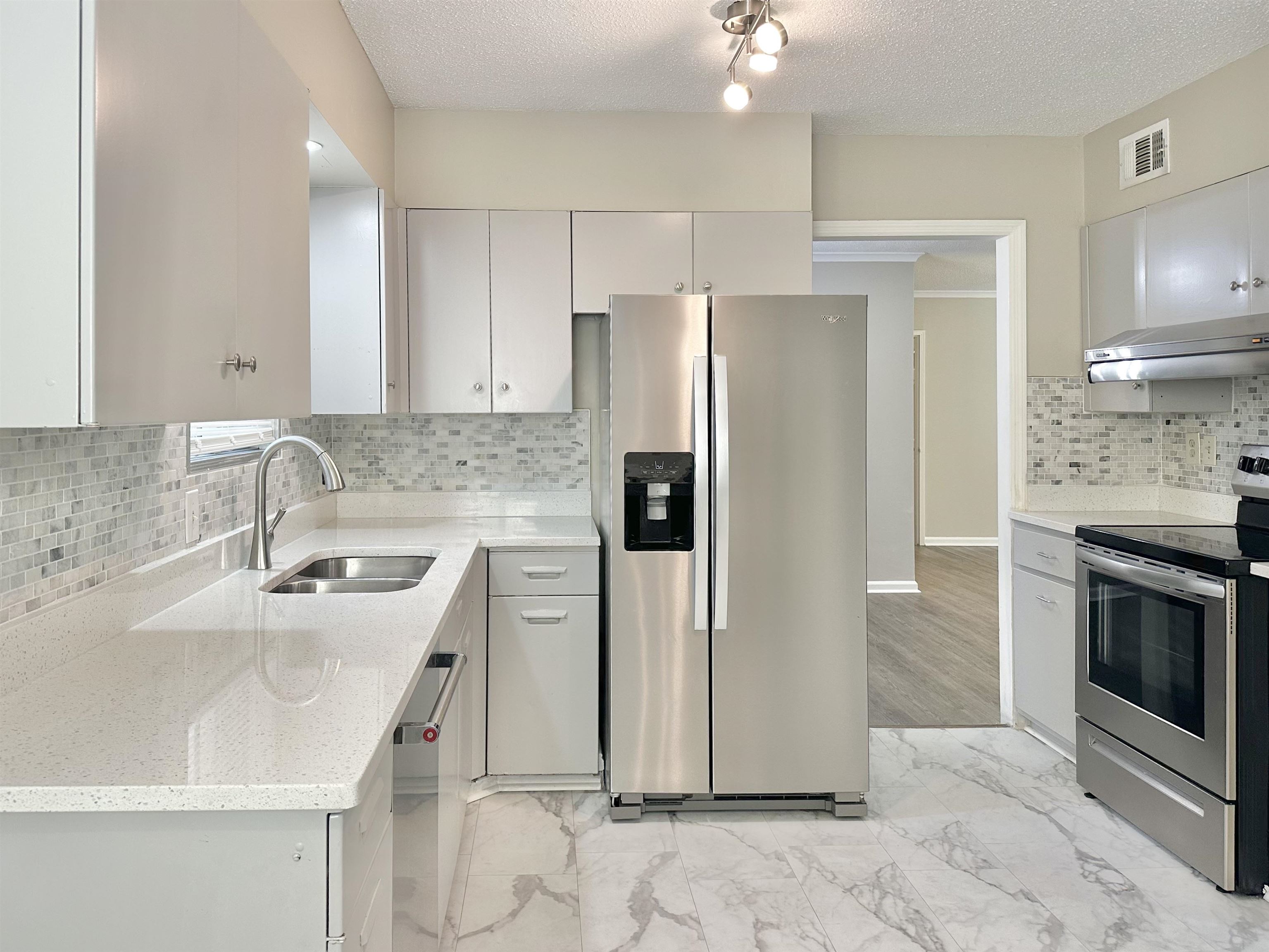 141 North White Station Road Memphis, TN 38117 - Photo 8 of 24 a kitchen with stainless steel appliances a refrigerator sink and microwave
