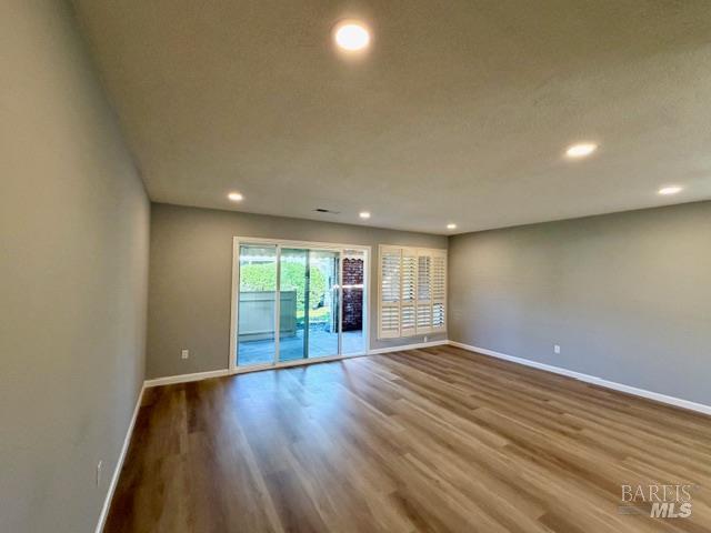 339 Twin Lakes Drive Santa Rosa, CA 95409 - Photo 3 of 15 an empty room with wooden floor and windows
