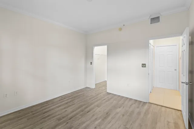 a view of a room with wooden floor