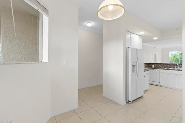 a view of a kitchen with white cabinets